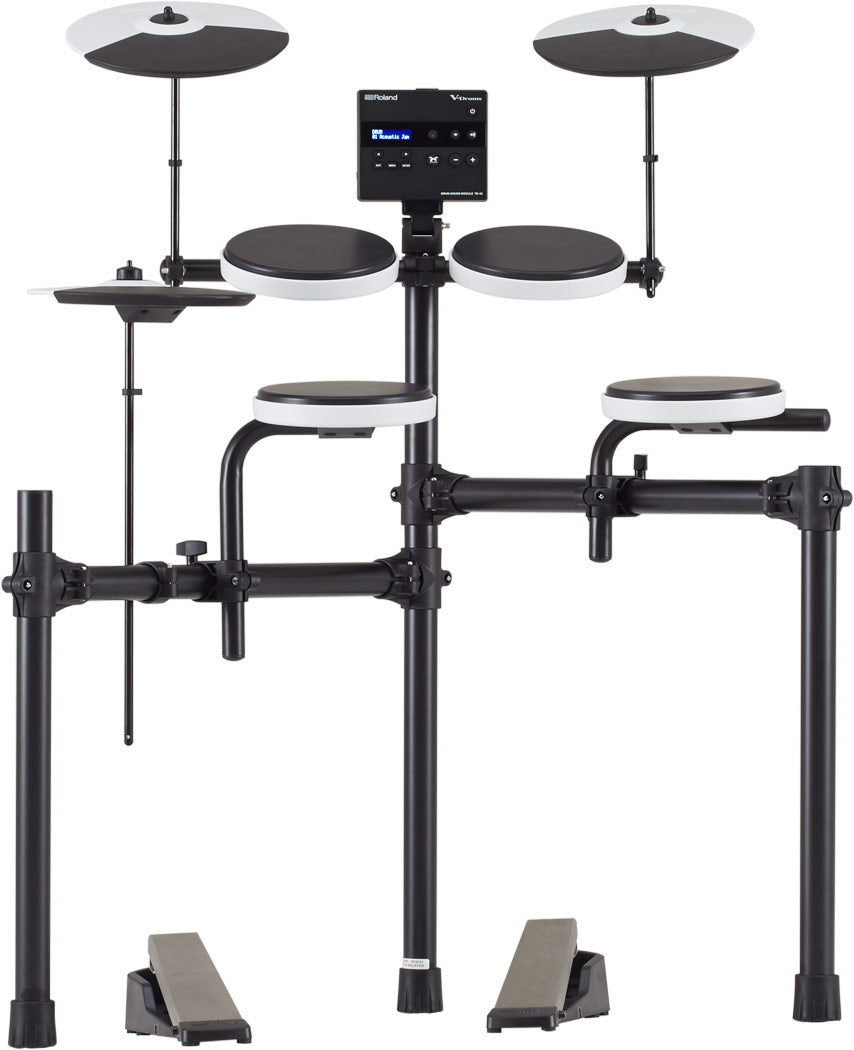 The image shows a Roland V-Drums electronic drum kit, featuring multiple rubber drum pads with white rims, two cymbal pads on adjustable stands, a central module with LCD display, and a black tubular rack. It includes two foot pedals and displays Roland branding. The compact, all-black design is ideal for home practice and recording, offering adjustable mounting, volume control, and diverse drum sounds in a space-saving setup.