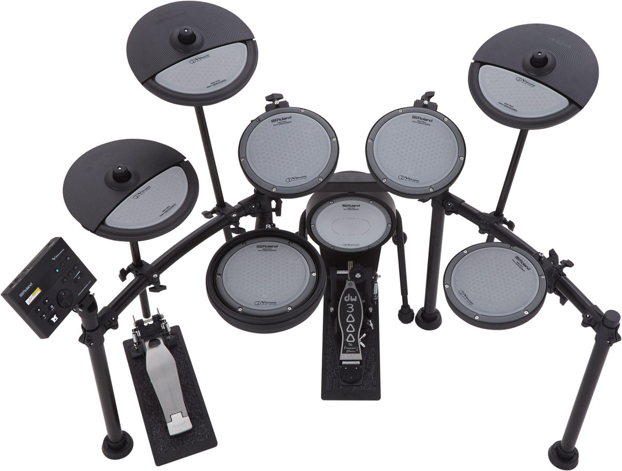 The image shows a Roland V-Drums electronic drum kit with multiple mesh-head pads, dual-zone crash and ride cymbals, a hi-hat pedal, bass drum pedal, and a black drum module. The kit features a sturdy black rack system and realistic mesh heads for natural feel. Designed for practice, recording, or live use, it offers volume control, diverse sounds, and space-saving benefits typical of Roland’s high-quality V-Drums series.