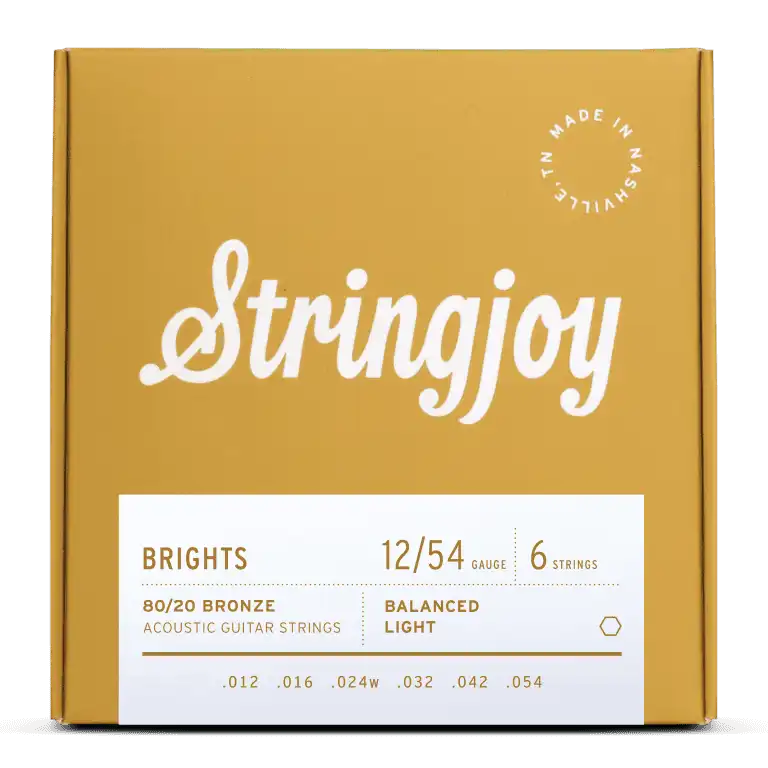 The image shows a package of Stringjoy "Brights" acoustic guitar strings. The light gauge 12-54 set is made of 80/20 bronze with six strings (.012 to .054). The packaging features a golden-yellow box with white script logo, a white info panel, and a "Made in Nashville" badge, highlighting a premium, professional presentation.