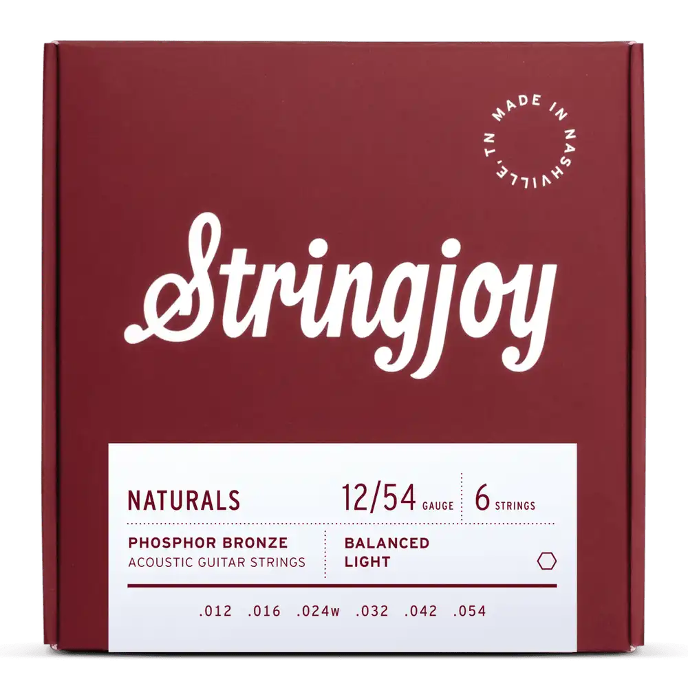 The image shows a package of Stringjoy "Naturals" phosphor bronze acoustic guitar strings, gauge 12-54, balanced light tension. The burgundy box features white script logo, clean typography, and a "Made in Nashville, TN" circular logo. The six strings have gauges .012, .016, .024w, .032, .042, .054. These light gauge strings offer a warm, balanced tone with professional, premium packaging.