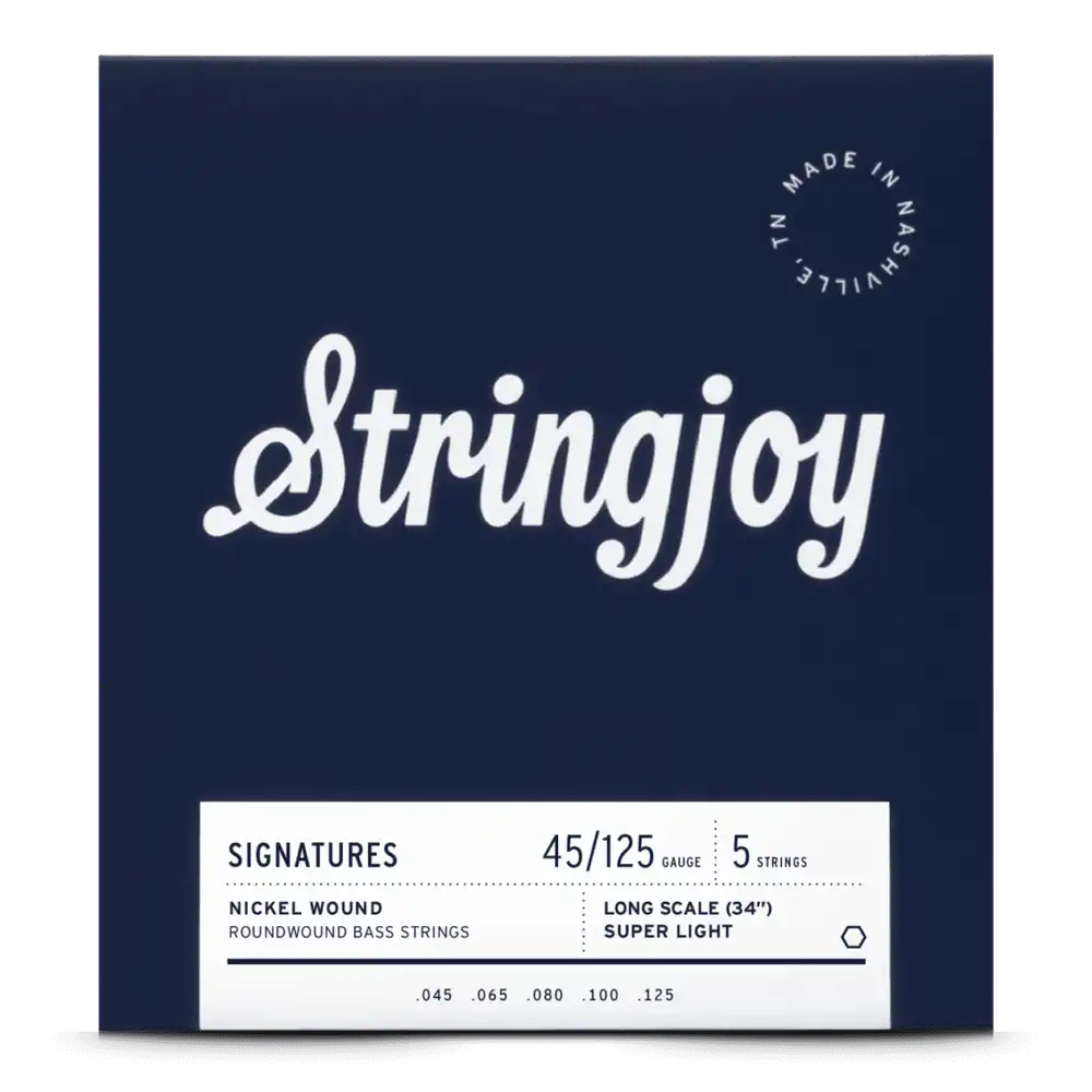 The image shows a package of Stringjoy 5-string bass guitar strings with a 45-125 super light gauge, designed for long scale (34") basses. The deep navy packaging features white cursive branding, a "Made in Nashville, TN" badge, and a white label listing nickel roundwound string specs (.045, .065, .080, .100, .125). This professional set is favored for playability and tone.