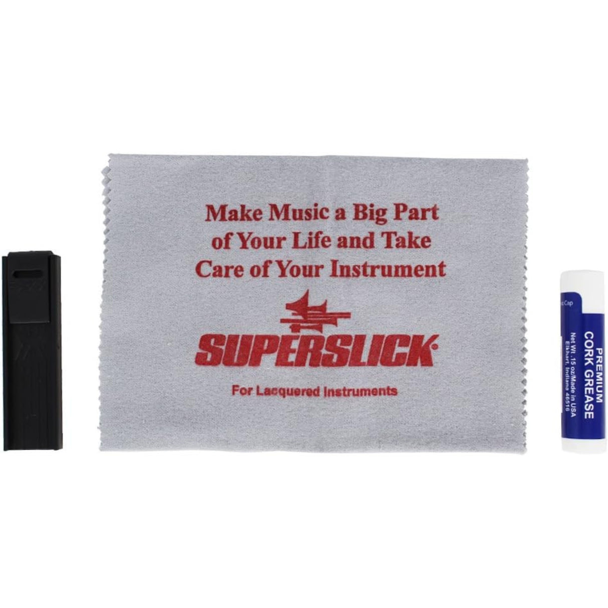 The image shows a musical instrument maintenance kit including a gray Superslick microfiber cleaning cloth labeled for lacquered instruments, a small black rectangular case likely for accessories, and a blue tube of cork grease used to lubricate woodwind cork joints. This basic care kit is designed to help clean, protect, and maintain brass or woodwind instruments.