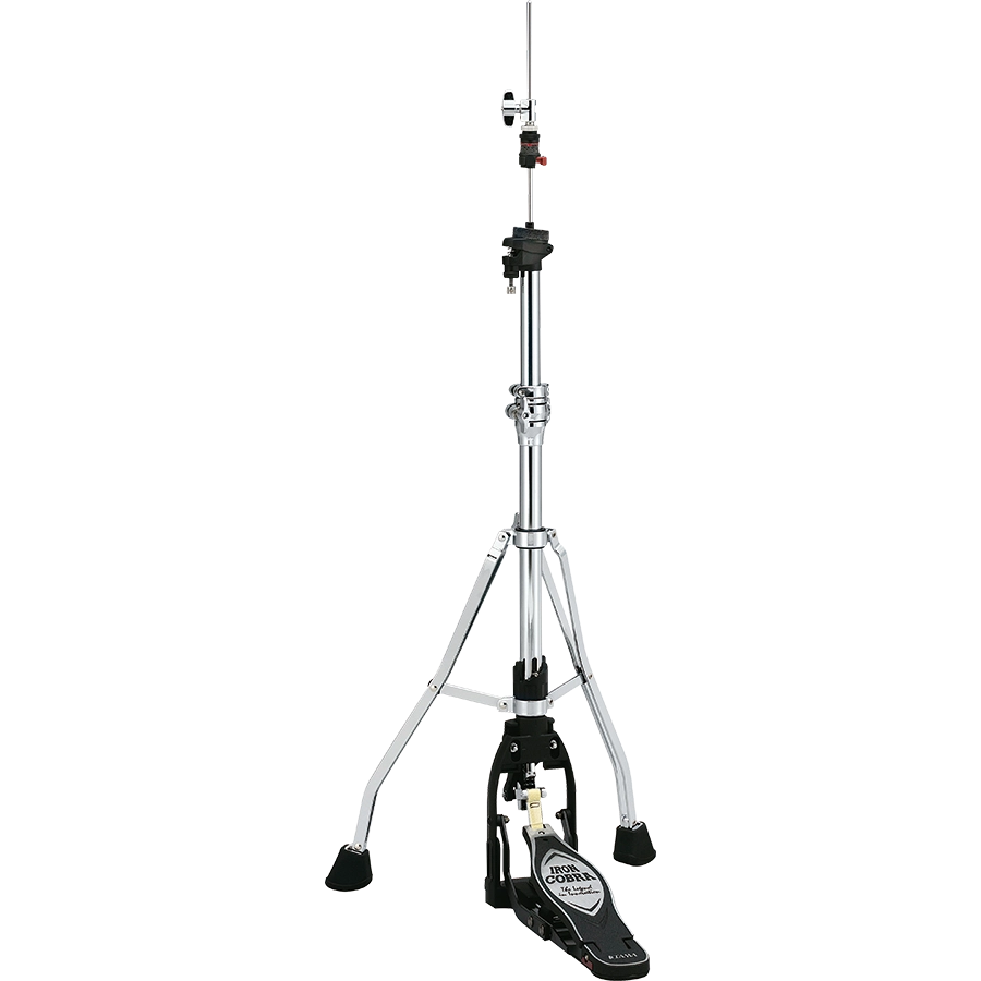 The image shows a hi-hat cymbal stand with a tall, adjustable chrome post, sturdy tripod base with rubber feet, and a black foot pedal featuring a brand logo. It includes clamps and adjustment mechanisms along the post. This essential drum hardware holds hi-hat cymbals (not shown) and allows drummers to control cymbal tension and create varied sounds from tight "chick" to open crashes.