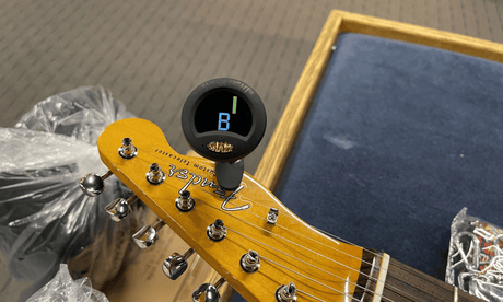 Tuner on guitar headstock