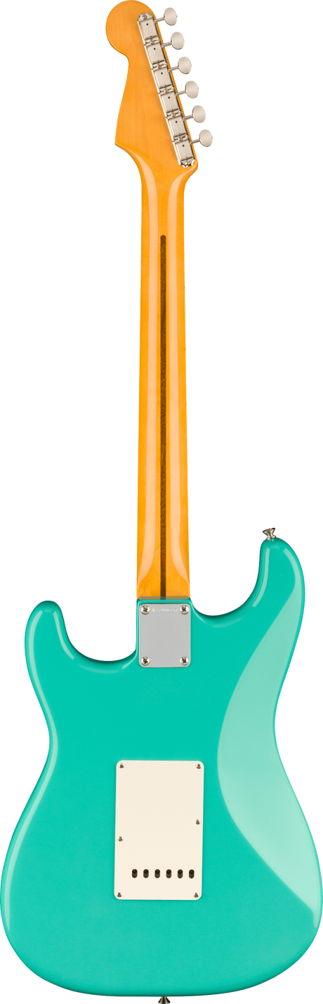 The image shows the back of a Stratocaster-style electric guitar with a glossy turquoise body and classic curves. It has an orange/amber maple neck with a maple fretboard and six tuning pegs on a Fender-style headstock. Visible hardware includes a white tremolo and pickup cavity covers, plus a metal neck plate. The vibrant color contrast and clean condition highlight this iconic American electric guitar design.