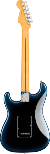 The image shows the back of a Fender Stratocaster-style electric guitar with a natural maple headstock featuring six chrome tuning pegs in a 6-in-line layout and visible Fender branding. The maple neck has a skunk stripe down its center. The deep blue, glossy body has classic Stratocaster contours, a chrome neck plate, and a black plastic back plate covering the tremolo cavity.