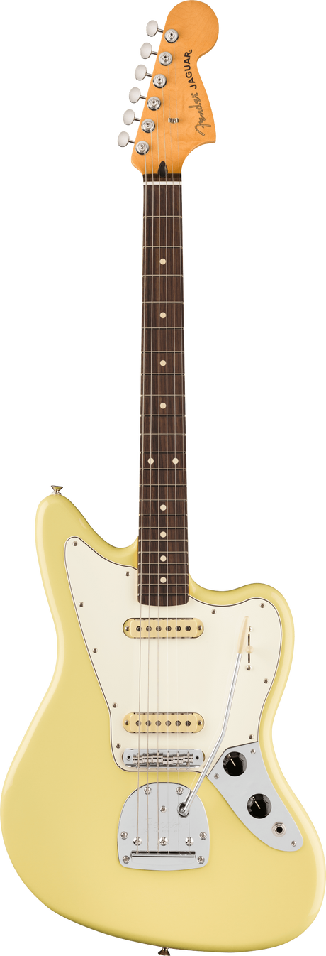 The image shows a Fender Jaguar electric guitar with its iconic offset body, cream single-coil pickups, white pickguard, multiple switches, rosewood fretboard with dot inlays, vintage-style tuning pegs, and a light yellow/cream finish. The "Jaguar" logo is visible on the headstock. Known for its 24" scale and unique tremolo, this classic model is popular among indie and surf rock musicians.
