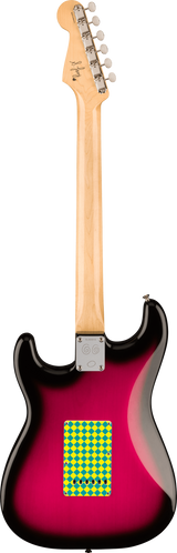 The image shows the back of a Stratocaster-style electric guitar with a natural wood headstock featuring 6 chrome tuning pegs with cream buttons. The neck is light-colored wood, attached to a contoured body with a pink-to-black sunburst finish. A chrome neck plate secures the neck. A small yellow and green diamond sticker is on the lower body. A signature or logo is visible on the headstock, and the guitar has a glossy, high-quality finish.