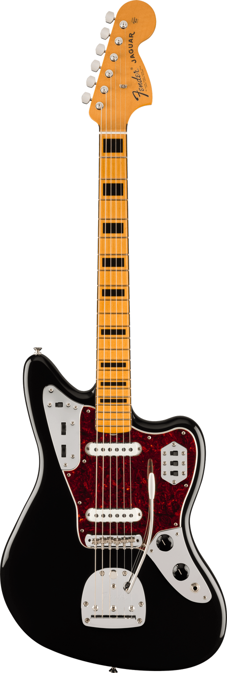 The image shows a Fender Jaguar electric guitar featuring the iconic Fender headstock with 6-in-line tuners, an offset black body with a white pickguard, dual single-coil pickups with white covers, and a maple neck with a maple fretboard. It has multiple control switches and a distinctive red tortoiseshell pickguard. This modern reissue retains the classic 1962 design known for its 24" scale and versatile electronics.