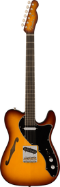 The image shows a Fender Telecaster Thinline electric guitar with a semi-hollow body and f-hole. It features a sunburst finish, chrome tuning pegs, black pickguard, two pickups, a traditional Telecaster bridge, and two control knobs. The dark fretboard has standard markers, and the classic Fender headstock displays the logo. This model blends the Telecaster’s iconic design with enhanced warmth and resonance.