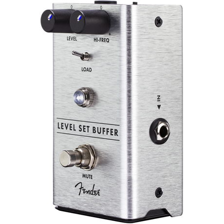 The image shows a Fender Level Set Buffer guitar effects pedal in a brushed aluminum enclosure. It features Level and Hi-Freq knobs, a Load switch, a Mute footswitch, and 1/4" input/output jacks. This pedal preserves signal integrity and tone in long cable runs or complex setups, allowing level adjustment while maintaining the guitar’s natural sound. Fender branding is visible on the pedal.