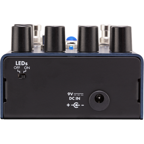 The image shows a compact black guitar effects pedal with four control knobs, input/output jacks, a 9V DC power input, and an LED indicator for on/off status. Designed to modify electric guitar sounds, it allows musicians to create effects like distortion, delay, or chorus by stepping on the pedal to engage or bypass the effect. Its durable build suits both live and studio use.