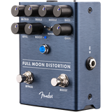 The image shows a Fender Full Moon Distortion guitar effects pedal with a brushed aluminum/blue finish and classic Fender logo. It features control knobs for Hi-Treb, Treble, Middle, Bass, Level, Boost, Texture, and Gain. There are two footswitches for bypass and boost, a small blue toggle switch, 1/4" input/output jacks, and a power input. Designed for versatile distortion and tone shaping.