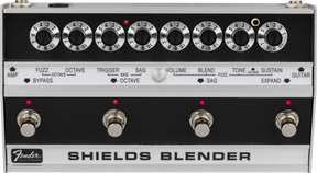The image shows a vintage Fender Shields Blender guitar effects pedal from the late 1960s/early 1970s. It features eight labeled rotary knobs controlling fuzz, octave, trigger, sag, volume, blend, tone, and sustain. The bottom section has four footswitches with red LEDs for selecting effects modes. The Fender logo and "SHIELDS BLENDER" branding are visible. This multi-effects unit blends sounds and is now a rare collectible.