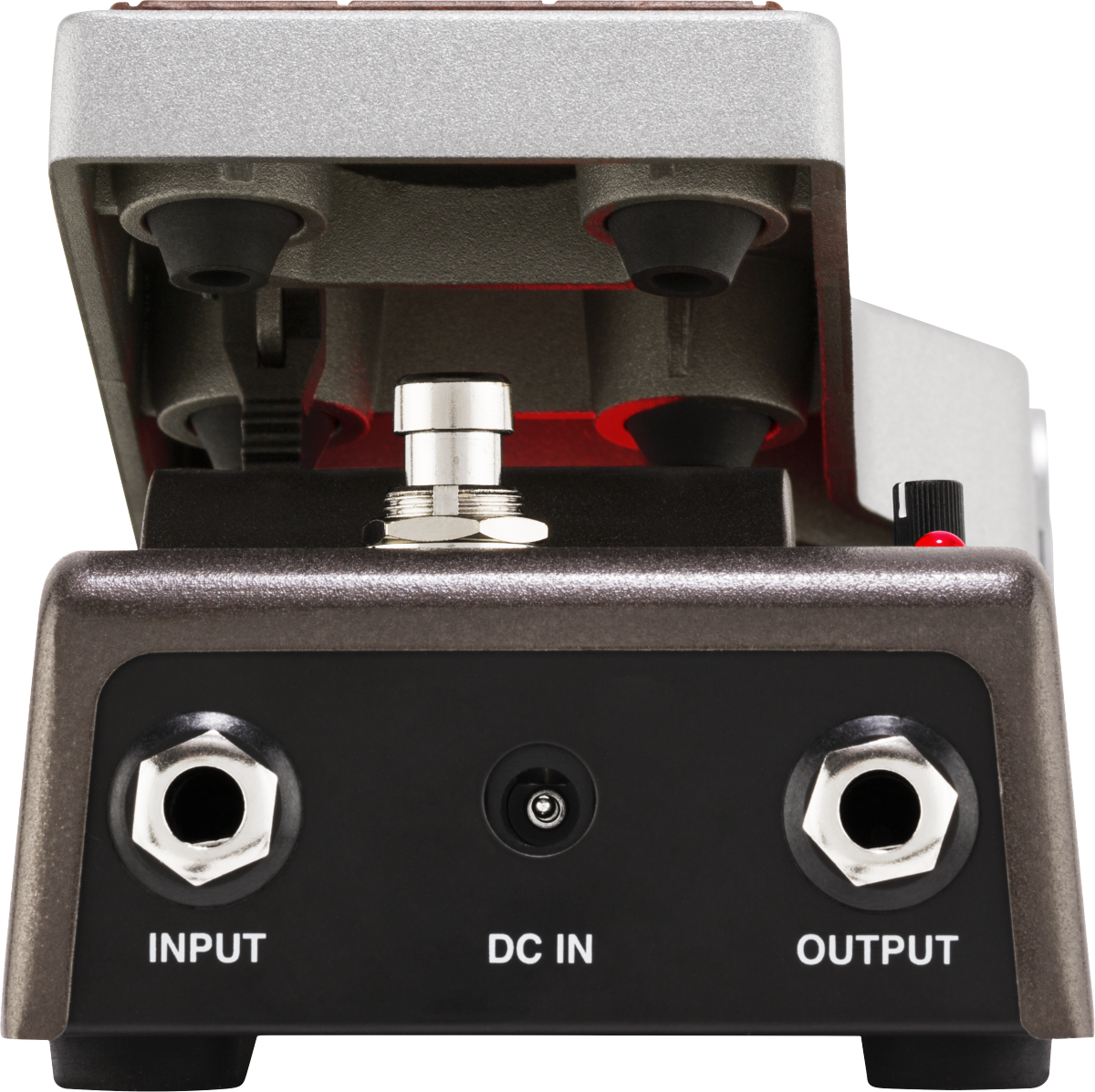 The image shows a guitar effects pedal with a sturdy metal housing and a hinged top revealing internal red-accented foot switch components. It features two 1/4" input/output jacks and a DC power input. Designed for durability, this pedal allows guitarists to modify their sound by activating effects like distortion or delay using the foot switch during performances.