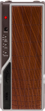 The image shows a wah expression pedal for electric guitar or bass, featuring a wood-grain textured footplate, control knobs and switches on the left side labeled RANGE, frequency settings (HI, MED, LOW MID, FREQ), LED and buffer ON/OFF switches, a red indicator LED at the top, and "WAH" branding on the lower left. The pedal creates the classic "wah-wah" sound by rocking it with the foot.