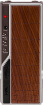 The image shows a wah expression pedal for electric guitar or bass, featuring a wood-grain textured footplate, control knobs and switches on the left side labeled RANGE, frequency settings (HI, MED, LOW MID, FREQ), LED and buffer ON/OFF switches, a red indicator LED at the top, and "WAH" branding on the lower left. The pedal creates the classic "wah-wah" sound by rocking it with the foot.