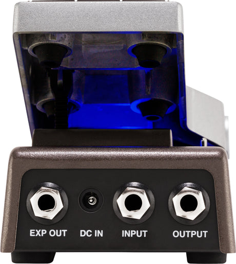 The image shows a guitar effects pedal with a metallic silver housing and a clear, blue-illuminated top revealing vacuum tubes inside. It features input/output jacks labeled "EXP OUT," "DC IN," "INPUT," and "OUTPUT." This tube-driven distortion or overdrive pedal offers warm tonal coloring, with the "EXP OUT" jack for expression pedal control. Its design suggests a high-quality, boutique-style effect device.