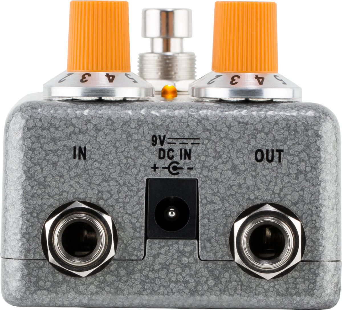 The image shows a guitar effects pedal with a gray textured metal enclosure. It features two orange-capped control knobs on top, labeled input and output 1/4" jacks on the front, a 9V DC power input, and an LED indicator light. This pedal modifies electric guitar sounds and is commonly used by guitarists to create effects like distortion, delay, and reverb in studio and live settings.