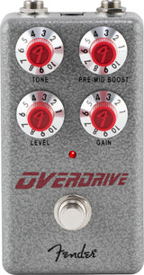 The image shows a Fender Overdrive guitar effects pedal with a gray/silver textured metal housing and classic Fender branding. It has four control knobs with red centers for Tone, Pre-Mid Boost, Level, and Gain, each numbered 1-10. A red LED indicates when active, with a footswitch below and input/output jacks on top. This compact stompbox adds warm, tube-style overdrive and sustain for rock and blues guitar tones.