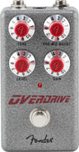 The image shows a Fender Overdrive guitar effects pedal with a gray/silver textured metal housing and classic Fender branding. It has four control knobs with red centers for Tone, Pre-Mid Boost, Level, and Gain, each numbered 1-10. A red LED indicates when active, with a footswitch below and input/output jacks on top. This compact stompbox adds warm, tube-style overdrive and sustain for rock and blues guitar tones.