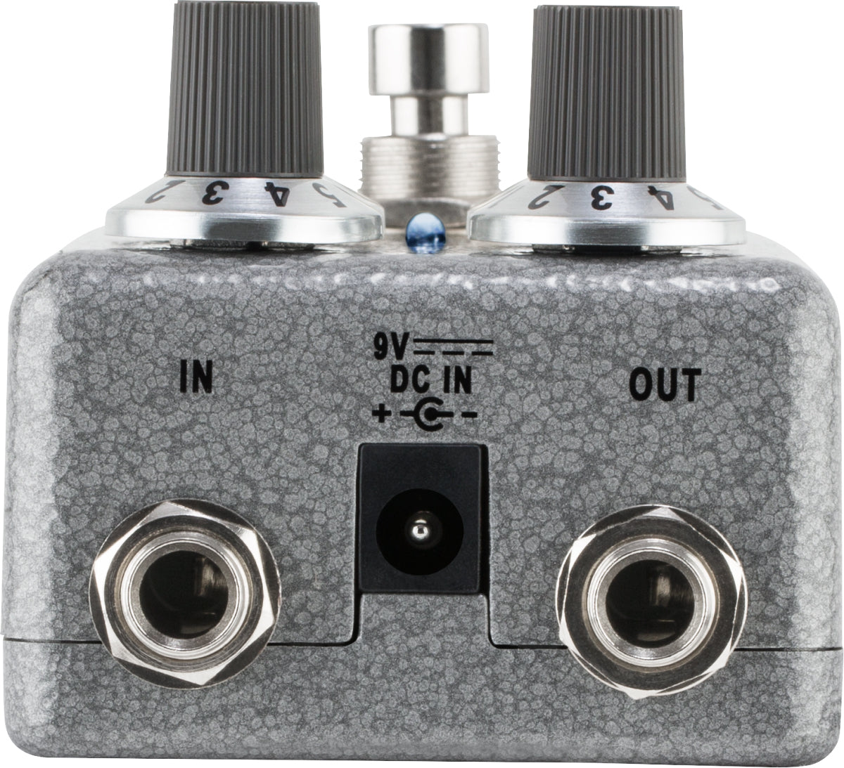 The image shows a guitar effects pedal with a textured gray/silver finish. It features two black ribbed control knobs, a metal footswitch, 1/4" input/output jacks labeled "IN" and "OUT," a 9V DC power input, and a small blue LED indicator. Designed to modify guitar sound, it connects between guitar and amplifier. Its sturdy metal build and professional components make it suitable for studio and live use.