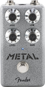 The image shows a Fender "Metal" distortion guitar effects pedal with a gray textured finish. It has four knobs—High (treble), Low (bass), Level (output volume), and Gain (distortion). The pedal includes two jacks at the top, a footswitch at the bottom, an LED indicator, and the Fender logo. Designed for heavy, distorted tones ideal for metal and hard rock guitar.