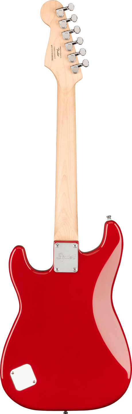 The image shows the back of a bright red (Candy Apple Red) Fender Stratocaster-style electric guitar. It has a natural maple neck and headstock with six chrome tuning pegs. A metal neck plate with a Fender logo attaches the neck to the body. The guitar features the classic contoured Stratocaster shape and a small rectangular cavity cover on the lower body. The clean finish suggests a new or promotional model of this iconic 1950s design.
