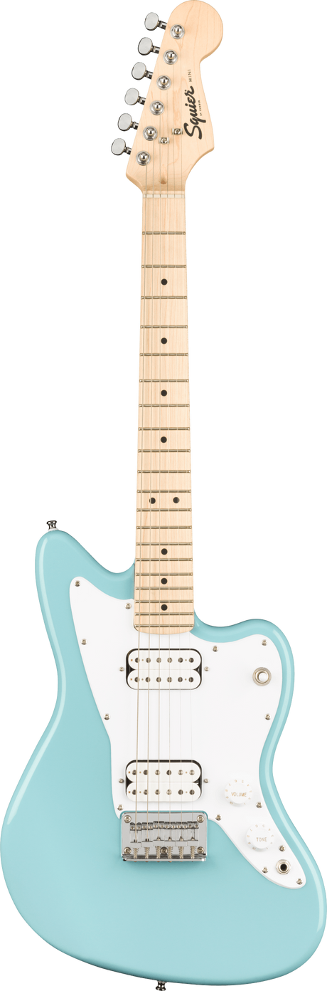 The image shows a Squier electric guitar modeled after the Fender Jazzmaster. It features a light blue/seafoam green body, white pickguard, two white-covered humbucker pickups, a maple neck with dot inlays, chrome tuning pegs, and traditional Jazzmaster offset body shape. The headstock displays the Squier logo. The hardware includes a chrome bridge and tailpiece, with standard volume, tone, and pickup controls, reflecting a vintage-inspired, affordable Fender design.