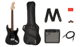 The image shows a complete Fender electric guitar starter pack including a black Squier Stratocaster-style electric guitar, a Fender Frontman practice amp, a black padded gig bag, an adjustable Fender strap, a guitar cable, tortoiseshell-pattern picks, and red Fender documentation. This beginner kit offers everything needed for new players to start learning electric guitar.