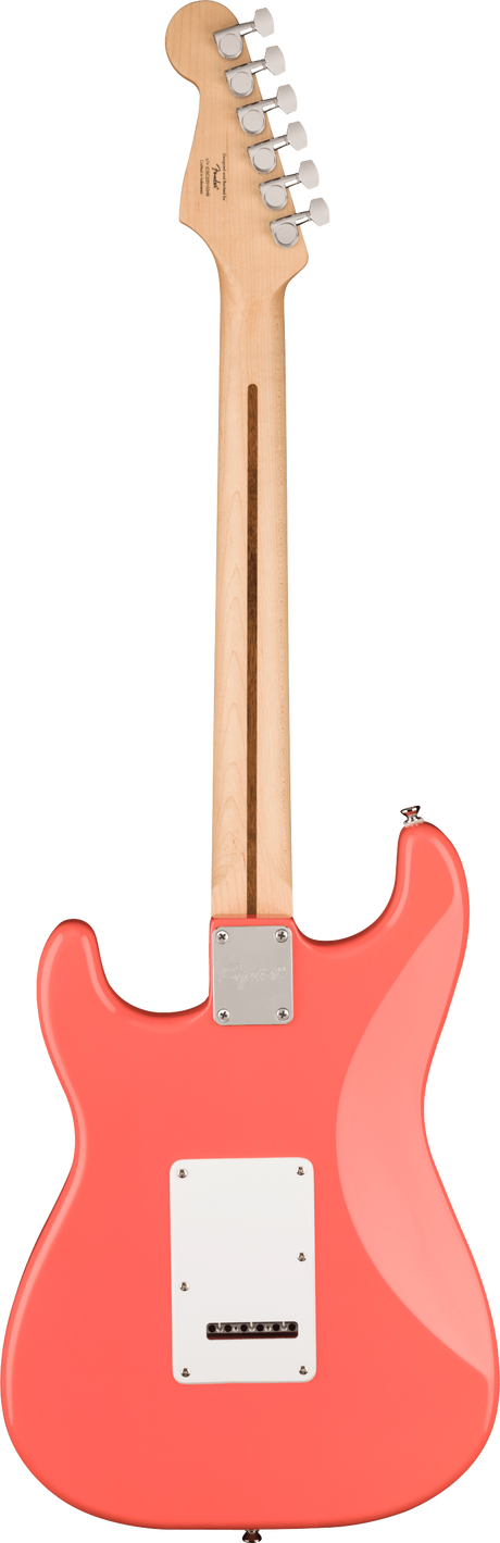 The image shows the back of a coral pink Stratocaster-style electric guitar with a glossy body and classic contours. It features a natural wood neck and headstock with six chrome tuning pegs in a 6-in-line layout. Visible are a white tremolo cavity cover, a chrome neck plate, and a truss rod adjustment slot. The bolt-on neck design and hardware suggest a Fender or similar model.