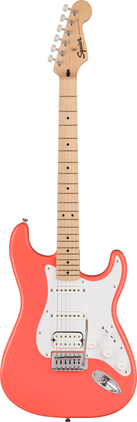 The image shows a Squier Stratocaster-style electric guitar with a coral pink contoured body and white pickguard. It features three pickups—two single-coils and a humbucker at the bridge—chrome hardware, a maple neck and fretboard with black dot inlays, and six-in-line chrome tuners. The Squier logo is visible on the headstock. This guitar offers a classic Fender look at an affordable price.