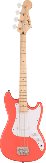 The image shows a Squier electric 4-string bass guitar with a bright coral body and white pickguard. It features a natural maple neck and fretboard, chrome tuning pegs, a single-coil pickup, and standard volume and tone knobs. The classic offset body and dot inlays reflect Fender’s style, combining vibrant aesthetics with accessible quality and classic bass sound.