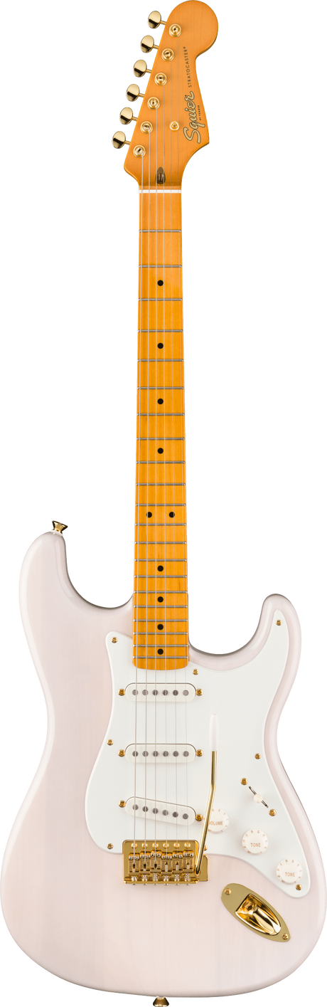 The image shows a Squier Stratocaster-style electric guitar with a light pink body and white pickguard. It features gold hardware, three single-coil pickups, standard controls, and a tremolo bridge. The maple neck has dot inlays, a natural finish, and six tuning pegs. The headstock displays the Squier logo. This higher-end Squier model combines vintage-inspired pink and gold aesthetics with Fender-style playability.