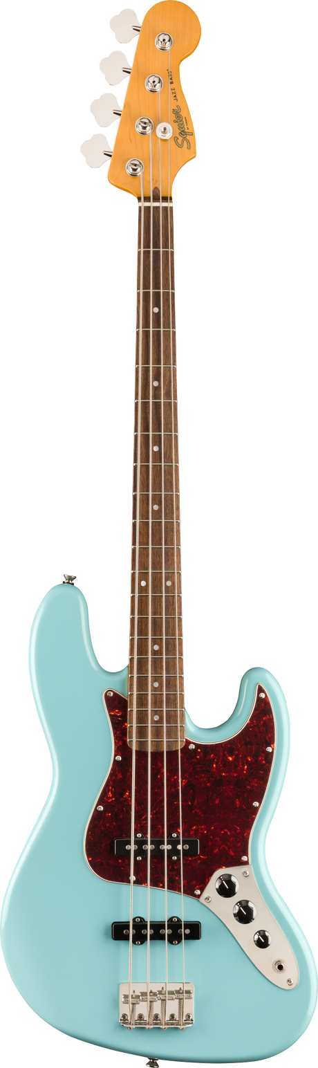 The image shows a Squier 4-string Jazz Bass guitar with a light blue/seafoam green body, classic offset waist shape, and a dark tortoiseshell pickguard. It features a maple neck with a dark rosewood or pau ferro fretboard, white dot markers, chrome hardware, two single-coil pickups, and standard volume and tone controls. The Squier logo is visible on the headstock, representing Fender’s affordable, classic-style bass line.