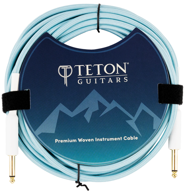 The image shows a Teton Teal 20ft guitar cable from the front, highlighting its teal-colored, coiled cable with metal connectors on both ends. The connectors have a durable, sleek design, and the cable appears flexible yet sturdy, suitable for professional guitar use. The background is plain, emphasizing the cable’s features and vibrant color.