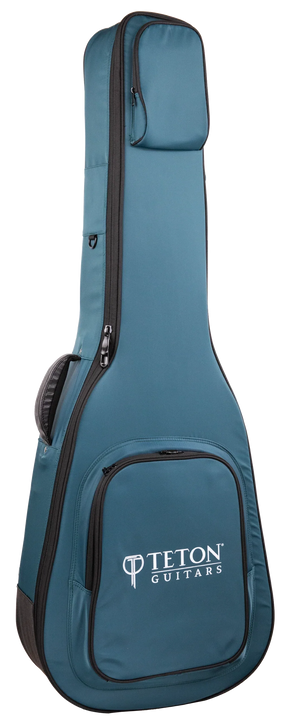 The image shows a teal/blue Teton Guitars padded gig bag shaped for acoustic guitars. It features the "TETON GUITARS" logo on the front pocket, multiple zippered compartments, padded shoulder straps, black zipper trim, and durable fabric. Designed for safe, lightweight transport, this soft case is ideal for carrying acoustic guitars and complements Teton’s branded instruments.