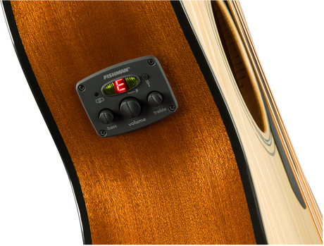 The image shows a close-up of an acoustic guitar’s side featuring a Fishman preamp/EQ system. It includes a digital tuner displaying "E," three control knobs labeled bass, volume, and treble, and the Fishman logo. The guitar has a rich amber wood grain with natural binding. This electronic setup enables amplification while preserving the acoustic tone and offers on-board tuning, ideal for live performance and recording.