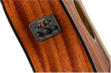 The image shows a Fishman acoustic guitar preamp and pickup system installed on a rich wood guitar body. It features a digital tuner displaying "E" in red, three control knobs for bass, volume, and treble, and a built-in chromatic tuner. The Fishman system allows players to amplify, shape tone, and tune their instrument accurately, commonly used by both amateur and professional musicians.