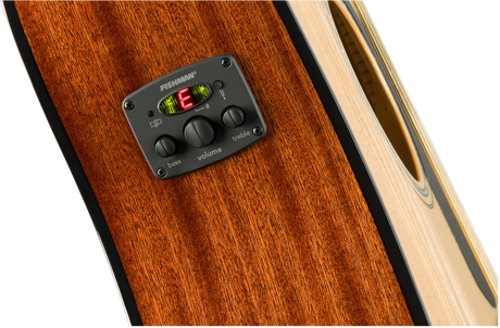 The image shows a close-up of an acoustic guitar’s Fishman preamp/EQ system mounted on its side. It features three control knobs for bass, volume, and treble, along with a built-in digital chromatic tuner with LED indicators. The guitar’s rich amber wood grain and part of the sound hole edge are also visible. This setup allows amplified play while preserving the guitar’s acoustic tone.