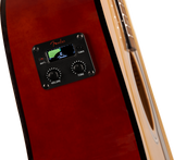 The image shows a close-up of a Fender preamp/pickup system installed in a red/burgundy acoustic-electric guitar. The black control panel features a digital LCD tuner with green lights, the Fender logo, two knobs labeled "VOLUME" and "TONE," a "TUNER" button, and a battery indicator. This electronics system enables amplification and tuning while preserving the guitar's acoustic tone for live or recording use.