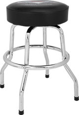 The image shows a classic guitar stool with a round, padded black seat, chrome-plated steel legs in a four-leg design, and a circular footrest ring. It has rubber feet caps to prevent slipping and possible branding on the seat. This sturdy stool is designed for musicians, offering comfortable seating and proper posture for playing guitar or other instruments.