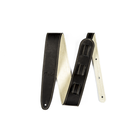 The image shows a black leather guitar strap with cream-colored lining and decorative contrast stitching. It features an adjustable length mechanism, padded construction for comfort, reinforced ends with attachment holes, and a visible brand logo. This classic, professional strap provides shoulder support for standing guitar players and has a versatile, timeless black and cream design.
