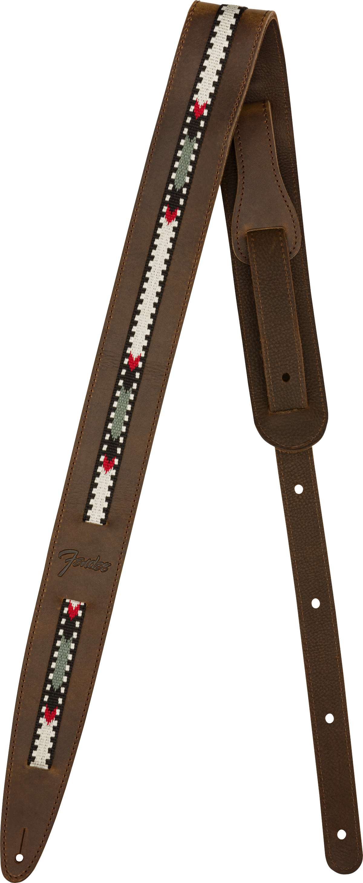 The image shows a brown leather guitar strap with visible stitching and a central woven fabric strip featuring a geometric pattern in white, black, green, and red. It has adjustment holes along its length and tapered ends for attachment. The "Fender" logo is visible, indicating the manufacturer. This strap combines functionality with a vintage, folk-inspired style.