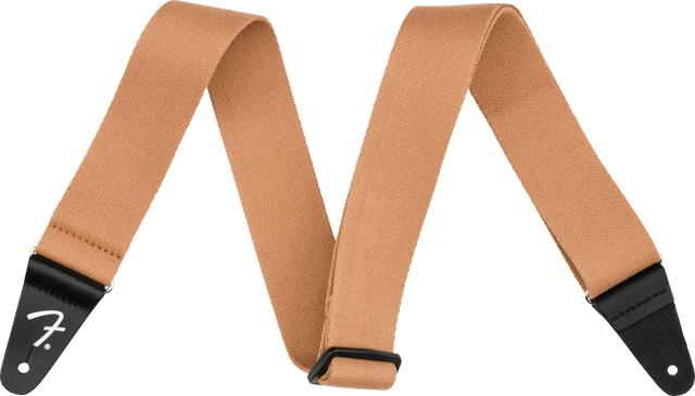 The image shows a tan/brown woven cotton or canvas guitar strap with black leather Fender-branded end tabs. It has an adjustable length and a classic, functional design. This essential accessory helps guitarists and bassists comfortably play while standing by distributing the instrument’s weight across the shoulder and torso, suitable for various musical styles and performance settings.