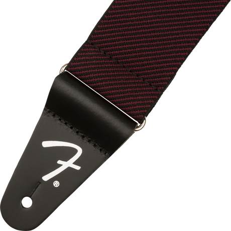 Guitar strap with red and black checkered pattern and Fender logo on a white background