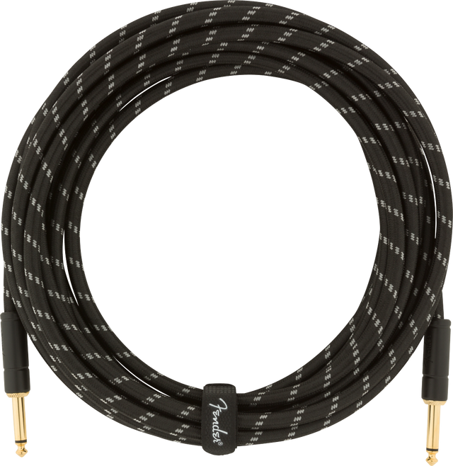 The image shows a professional Fender instrument cable with a black braided exterior featuring white/gray accents. It has gold-plated 1/4" TS connectors on both ends and is coiled, indicating a length of 15-20 feet. The cable includes visible Fender branding and is designed to reduce interference and ensure reliable signal transmission for electric guitars, basses, and other electronic instruments.
