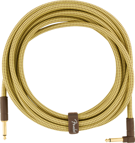 The image shows a Fender guitar cable with a yellow/tan tweed woven fabric covering featuring a diamond pattern. It has gold-plated 1/4" connectors: one straight and one right-angle plug. A brown fabric band with the Fender logo wraps the coiled cable. Designed for electric instruments, the vintage-style sheath offers durability, reduced tangling, and a classic look, while the right-angle plug minimizes strain on guitar input jacks.