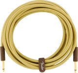 The image shows a high-quality Fender guitar cable with a vintage-style yellow and brown tweed woven fabric outer covering. It has gold-plated 1/4" TS connectors on both ends and a Fender-branded velcro strap for neat storage. This professional-grade instrument cable connects guitars or basses to amps and pedals, offering reliable signal quality and a classic vintage look.