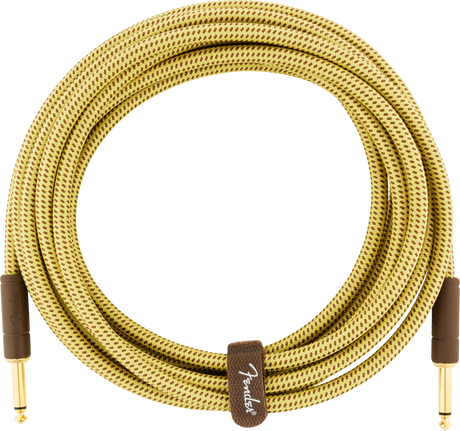 The image shows a high-quality Fender guitar cable with a vintage-style yellow and brown tweed woven fabric outer covering. It has gold-plated 1/4" TS connectors on both ends and a Fender-branded velcro strap for neat storage. This professional-grade instrument cable connects guitars or basses to amps and pedals, offering reliable signal quality and a classic vintage look.